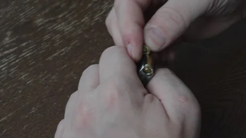 Man Emptying Pistol Magazine by Unloading Bullets Close Up Stock Footage 340405513