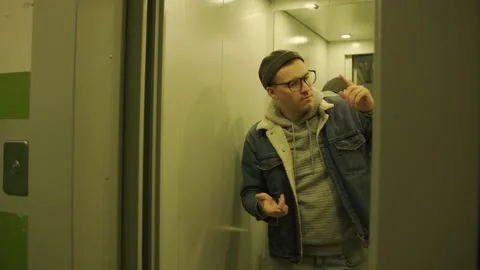 Man Energetically Dances in an Elevator Stock Footage 277447886