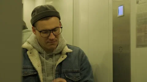 Man Energetically Dances in an Elevator Stock Footage 277447901