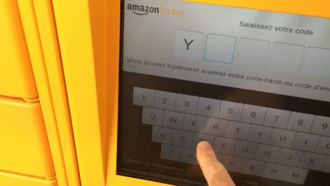 Man enetering code for Amazon locker parcel delivery Stock Footage 88320850