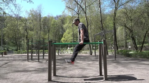 A man engaged in the bars in the Park 4K Video stock 90684329