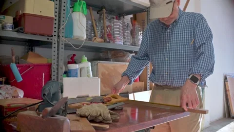 Man Engaged in Carpentry Work Inside a Storage or Workshop Setting Stock Footage 312730746