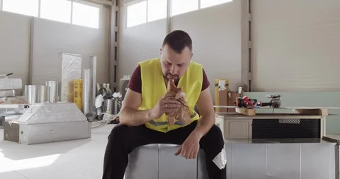 A man, engaged in construction, wants to take a break and take a nap. Video stock 127098555
