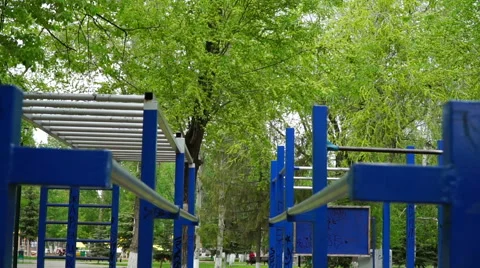 Man is engaged on the parallel bars outdoors Stock Footage 63051729