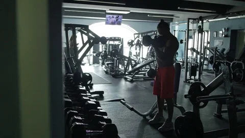 The man is engaged on simulators in gym Видео 70989842