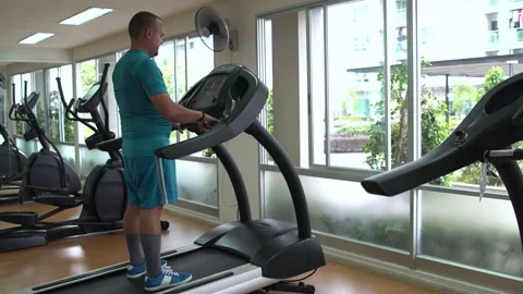 Man is engaged in on the treadmill Stock Footage 91523670