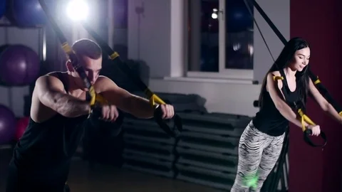 Man is engaged in trx exercises in the studio Stockbeeldmateriaal 75100444