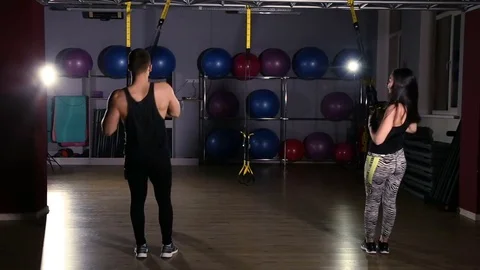 Man is engaged in trx exercises in the studio Stockbeeldmateriaal 76525181