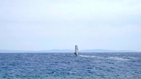 A man is engaged in windsurfing in the red sea, mountains in the background, wat 動画素材 240199312
