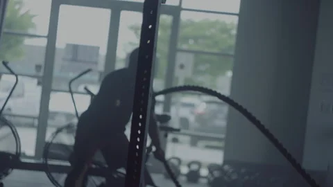 Man engages in intense rope workout at local gym during evening session Stock-Footage 312707737