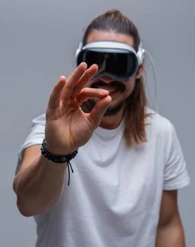 Man engages with a virtual world using a mixed reality spacial computer headset 写真素材