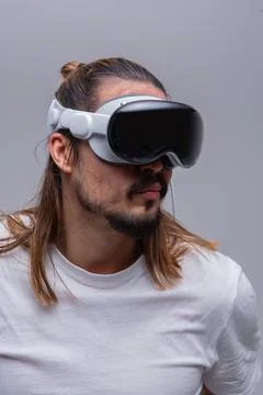 Man engages with a virtual world using a mixed reality spacial computer headset 写真素材
