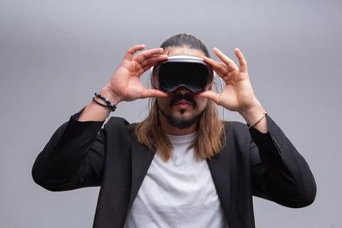 Man engages with a virtual world using a mixed reality spacial computer headset Stock Photos