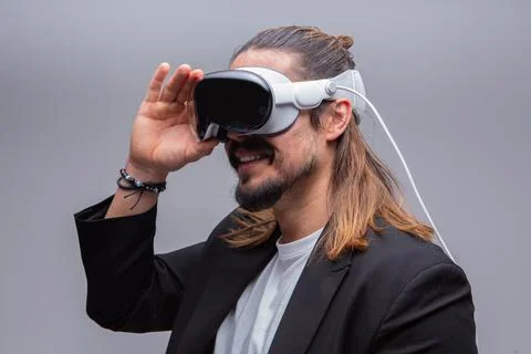 Man engages with a virtual world using a mixed reality spacial computer headset Stock Photos