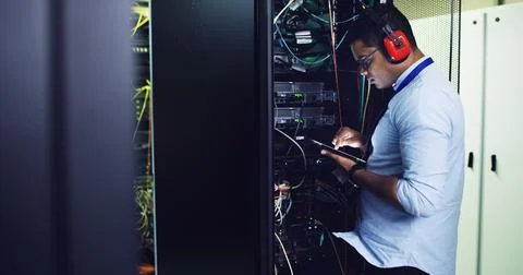 Man, engineer and database on tablet in server room for software, update system Stock Photos