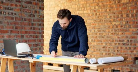 Man, engineer and drawing at site with document, blueprint and design for a.. Foto stock