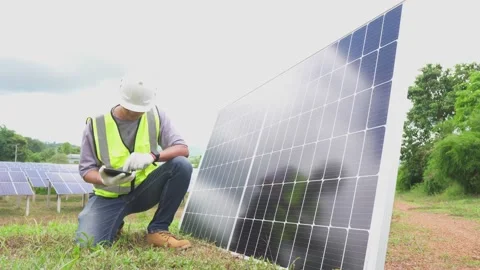 The man engineer checking with a tablet the field of photovoltaic solar panels. Stock Footage 210818694