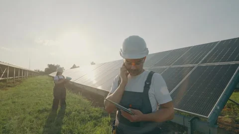 Man engineer collects effective information about solar panels from worker Stock Footage 261155548