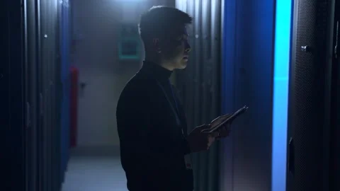 Man engineer doing diagnostics of networks with tablet in hand while standing in Stock Footage 163693356