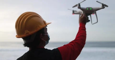 Man engineer flying with drone while wearing protective mask Stock Footage 145430772