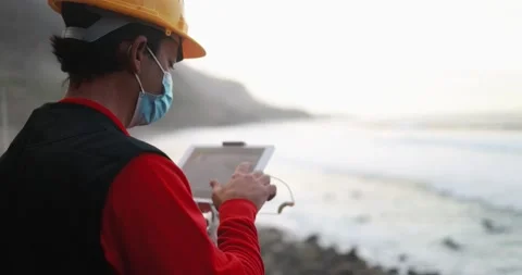 Man engineer flying with drone while wearing protective mask Stock Footage 145430792
