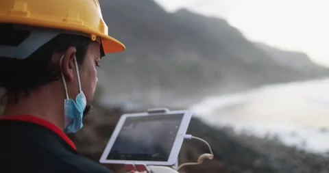 Man engineer flying with drone while wearing protective mask 動画素材 145430840