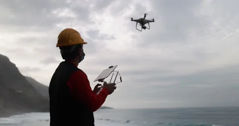 Man engineer flying with drone while wearing protective mask 動画素材 145430864