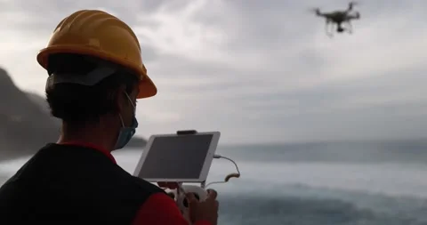 Man engineer flying with drone while wearing protective mask Stock Footage 145430926