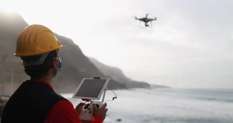Man engineer flying with drone while wearing protective mask Stock Footage 145430955