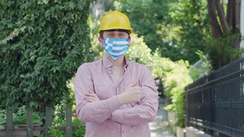 Man engineer with Greece flag mask. Stock Footage 135982118