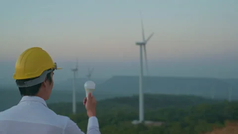 A man engineer is holding Light bulb wearing a protective helmet on her head  Stock Footage 149060984