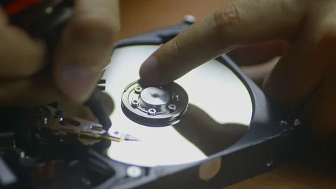Man engineer is making diagnostics of hard drive at table in service center Stock Footage 126696216