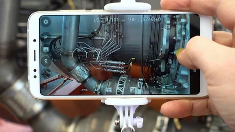 A man engineer photographs a jet engine. The man's hand takes a picture of th Stock Footage 88767373