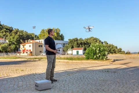 Man, an engineer pilot, prepares air device for take-off, for testing and Stock Photos