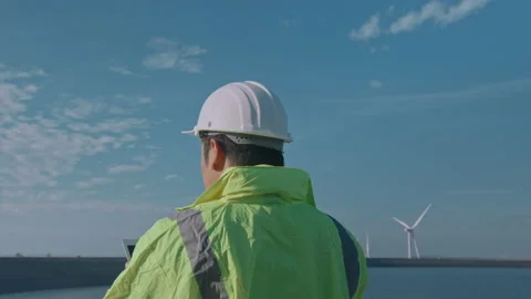 A man engineer is putting a protective helmet on her head at sunset.. Stock Footage 169240382