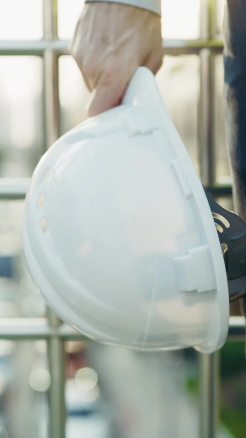 Man engineer shows hardhat emphasizing safety regulations Video stock 312811268