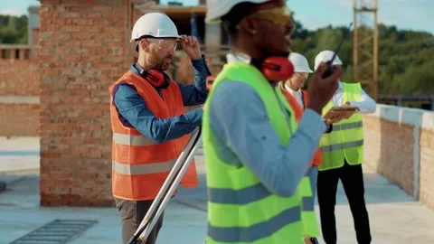 Man engineer surveyor takes measures with theodolite stand helmet hardhat Stock Footage 139338882