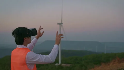 A man engineer is using vr box Analytics engineering data in a field wearing  Vídeo Stock 149047872