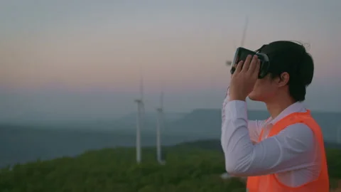 A man engineer is using vr box Analytics engineering data in a field wearing  Stock Footage 149048538