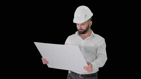 Man engineer walking in helmet looking at project of reconstruction, Alpha Stock Footage 133251291