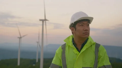 A man engineer is wearing a protective helmet on her head, using tablet Analy Stock Footage 169238734