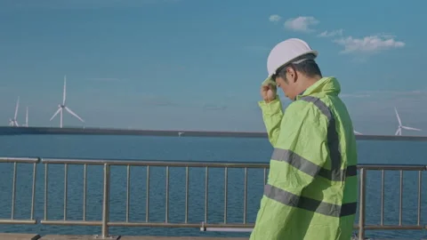 A man engineer is wearing a protective helmet on her head, using tablet Analy 스톡 동영상 169240516