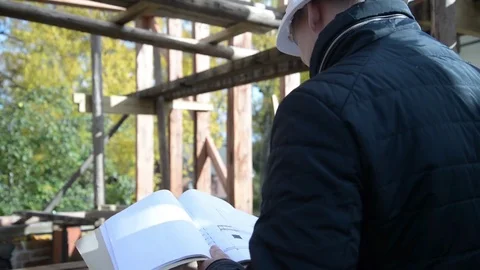 Man engineer working with wood house plan Stock Footage 82678982