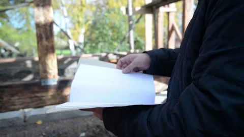 Man engineer working with wood house plan Stock Footage 82678983
