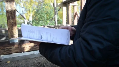 Man engineer working with wood house plan Stock-Footage 82678991