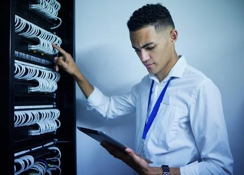 Man, engineering and tablet in server room or data center inspection, system Stock Photos