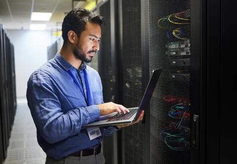 Man, engineering laptop and data center, server room inspection or system Stock Photos