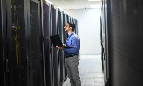 Man, engineering laptop and server room, data center inspection or system Stock Photos