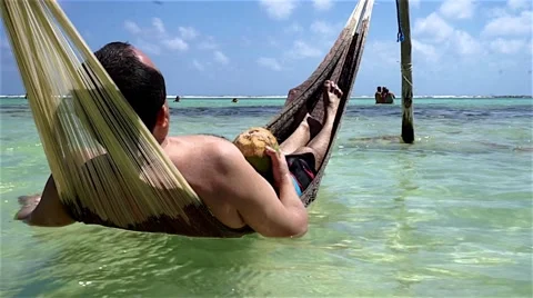 Man enjoing an hammock in the water Stock Footage 47784677