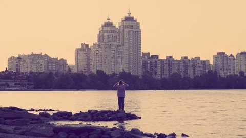 Man is enjoing the sunset at the river Stock Footage 116392285